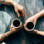 Two people talking over coffee